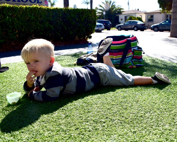 Lounging on the grass enjoying a meal after swim class